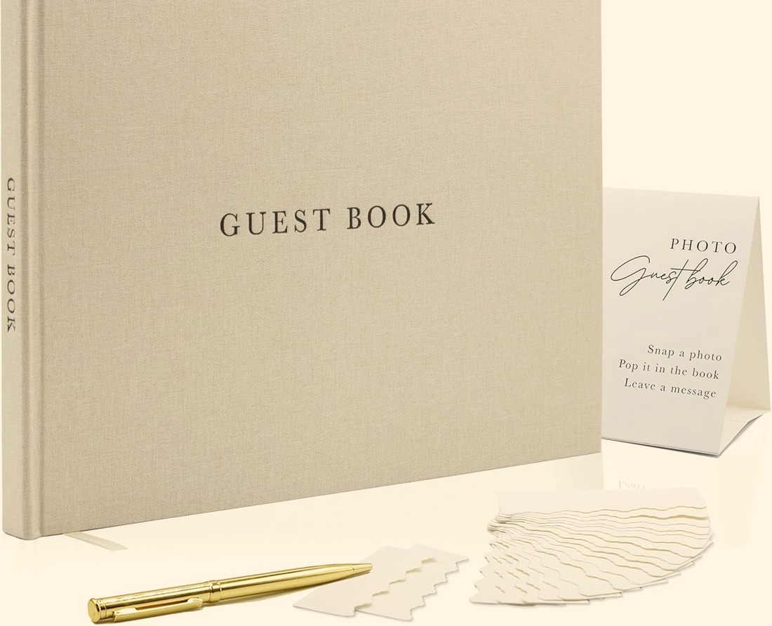 Linen guest book with a gold pen and photo corners